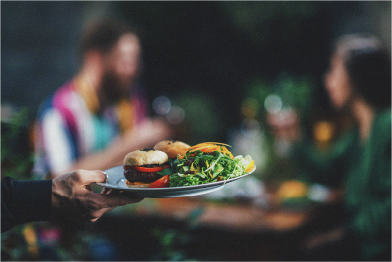 Vegan burger with salad being served at a restaurant